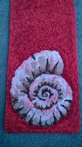 This ammonite was created by batik and embroidery.