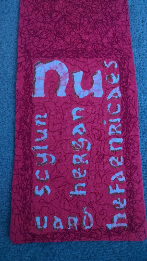 This is the first line of Caedmon's hymn of praise to the creator in Old English (preserved for us by the Venerable Bede). This was created in batik and embroidered.